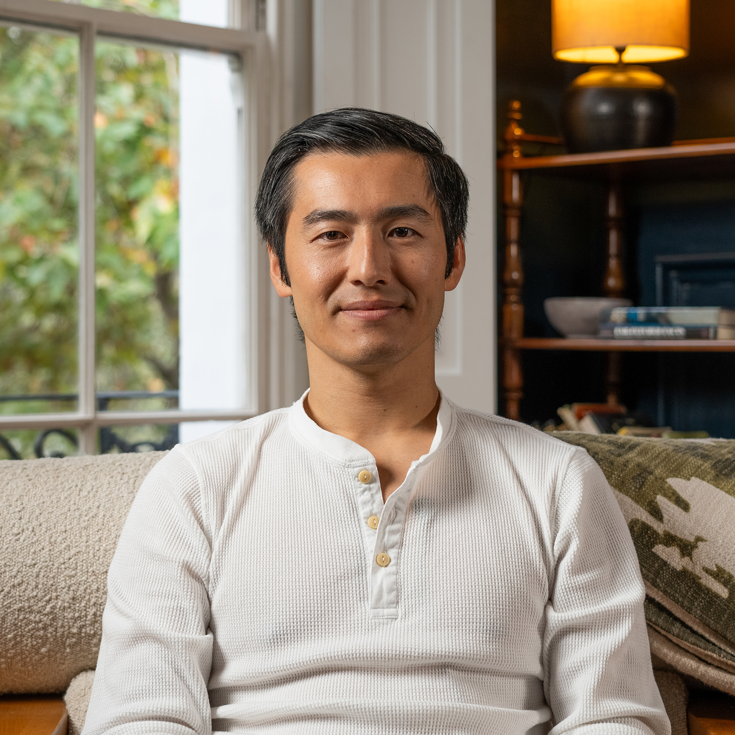 Man sat on sofa looking into camera