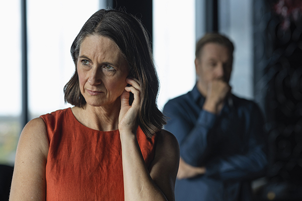 Woman looking upset with husband in the foreground